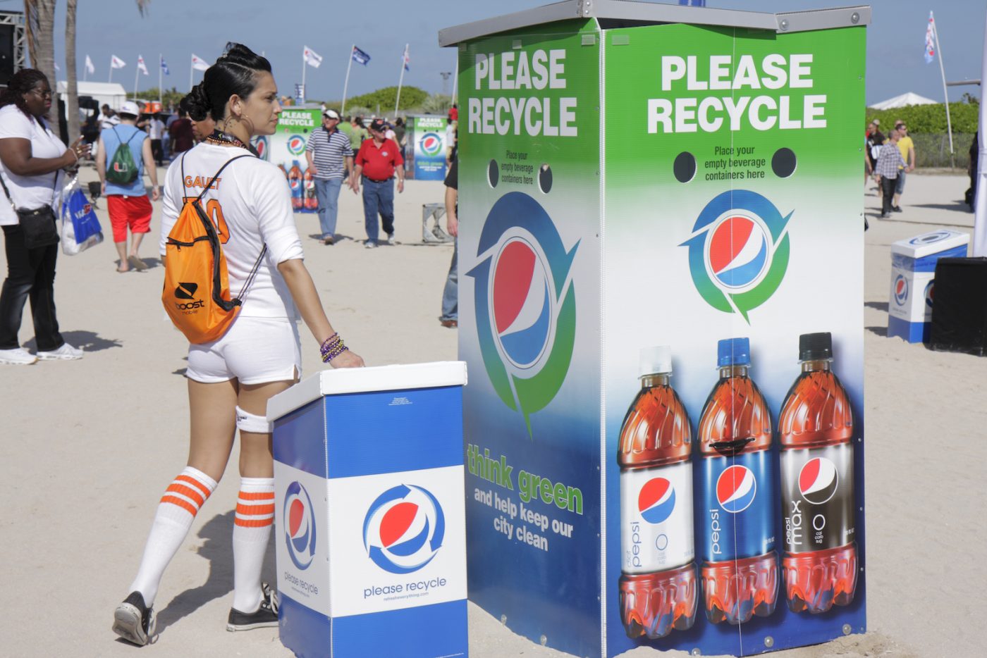 Recycling bins decorated Pepsi bottles and with the Pepsi logo at a sporting event