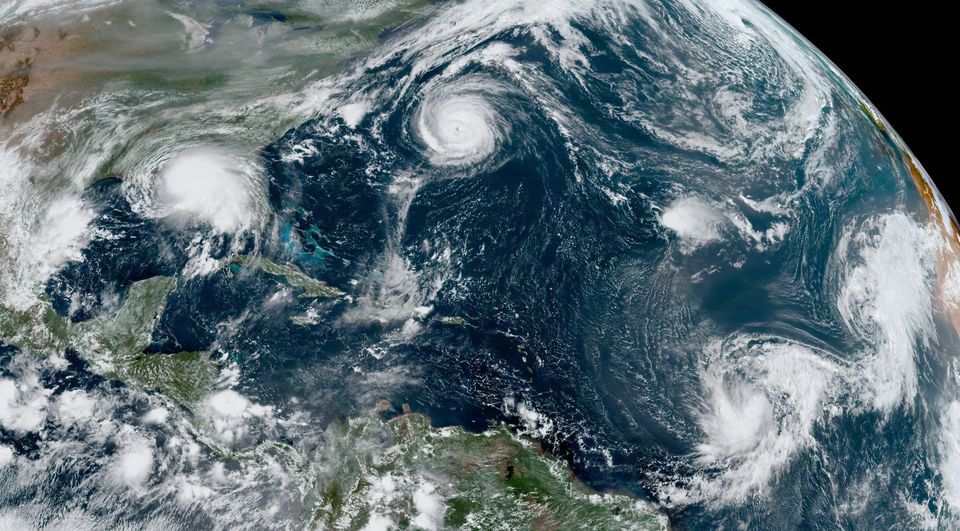 A satellite view shows the five hurricanes growing in the Atlantic ocean