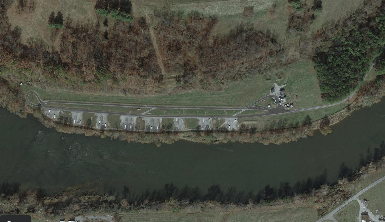 An aerial view of concrete pads next to a river