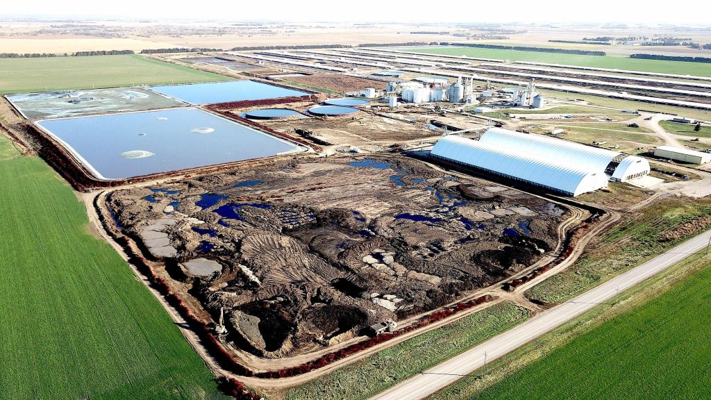 An aerial view of the AltEn facility, surrounded by green fields.