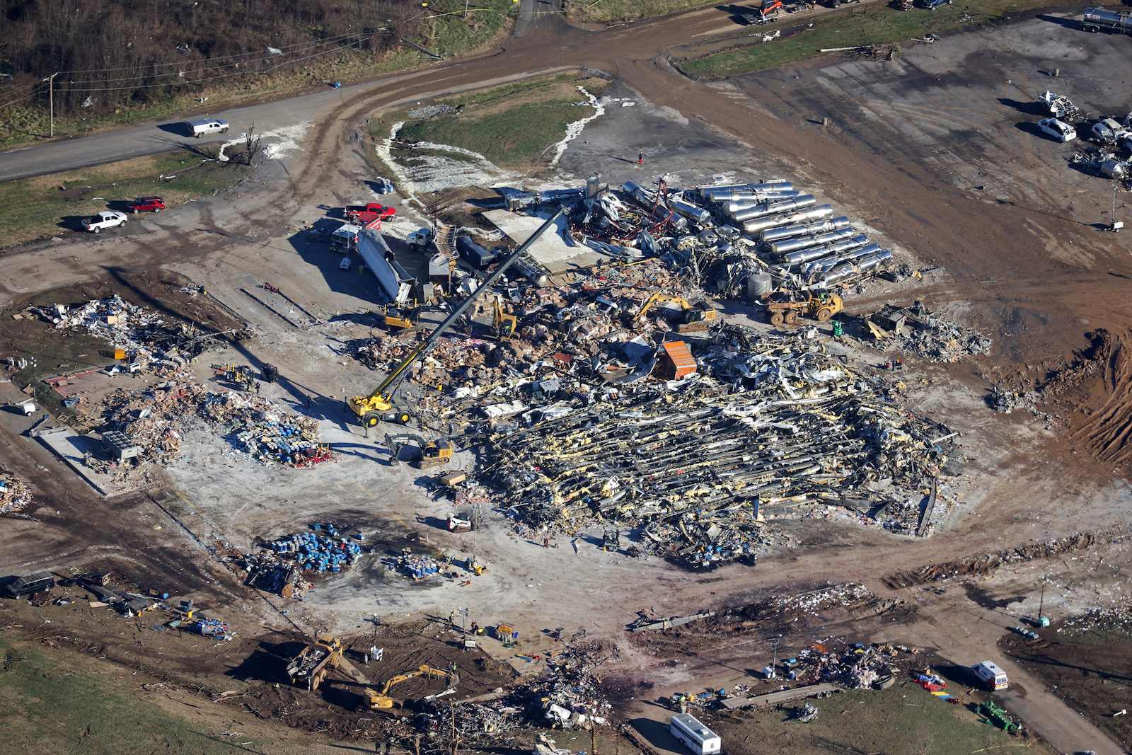 In this aerial view, crews clear the rubble at the Mayfield Consumer Products candle factory after it was destroyed by a tornado three days prior, on December 13, 2021.