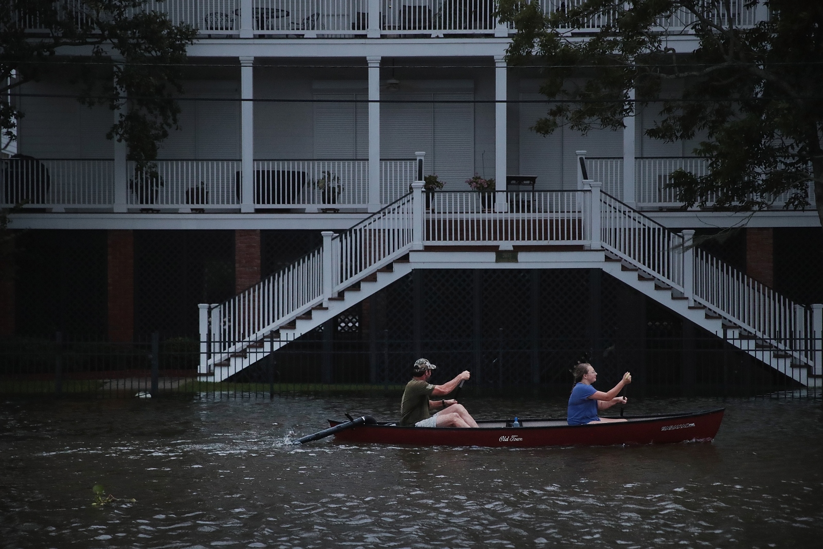 People canoe along the shore of Lake Pontchartrain after flooding in the wake of Hurricane Barry in Mandeville, Louisiana, in July 2019.