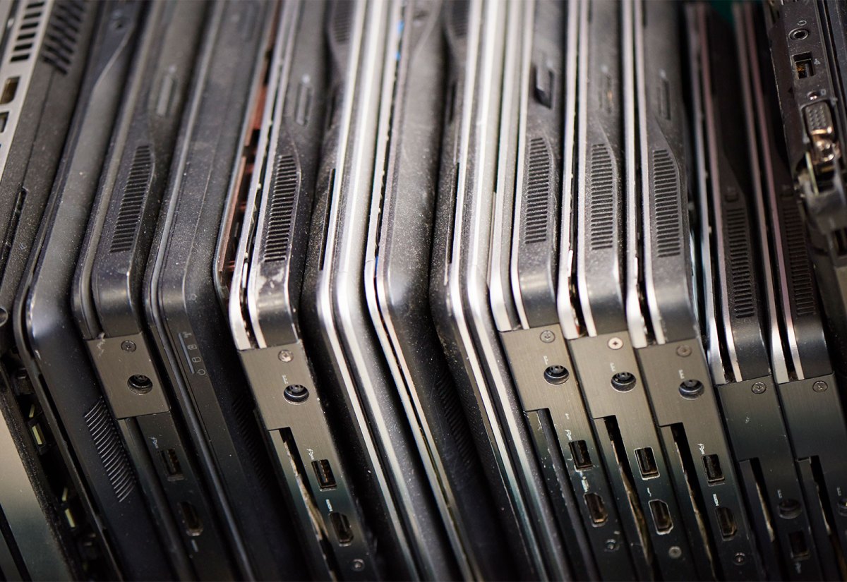 close up view of stacked old dusty laptops