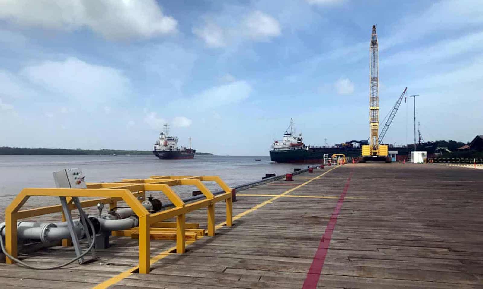Vessels carrying supplies for an offshore oil platform operated by ExxonMobil at a wharf on the Demerara River, south of Georgetown.