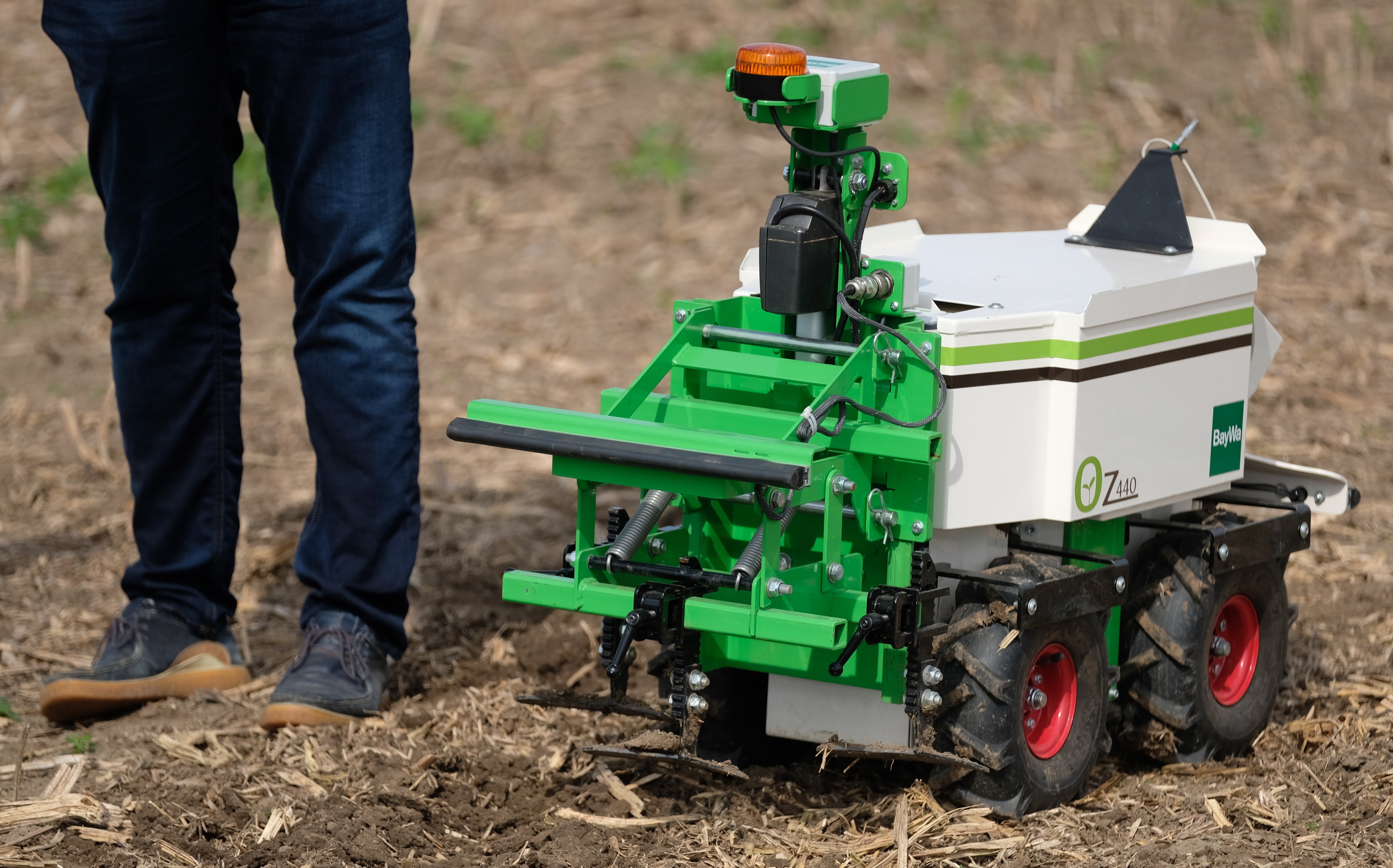 The "OZ" field robot at a 2021 technology show in a field in northern Saxony. The device can independently work the soil or remove weeds.