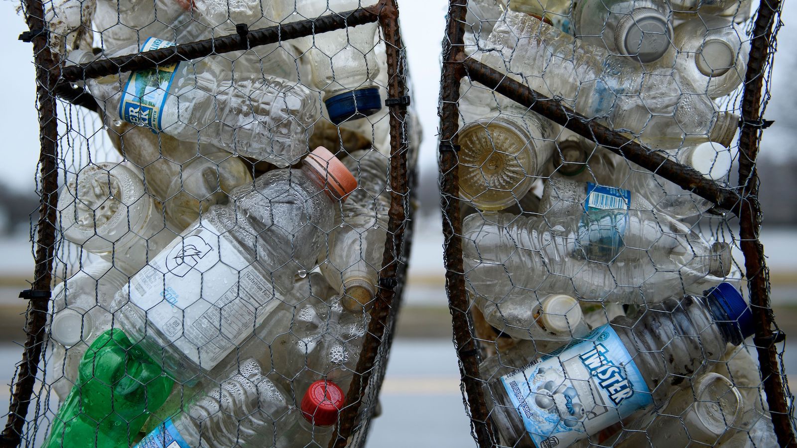 Plastic bottles in two side-by-side trash tubes