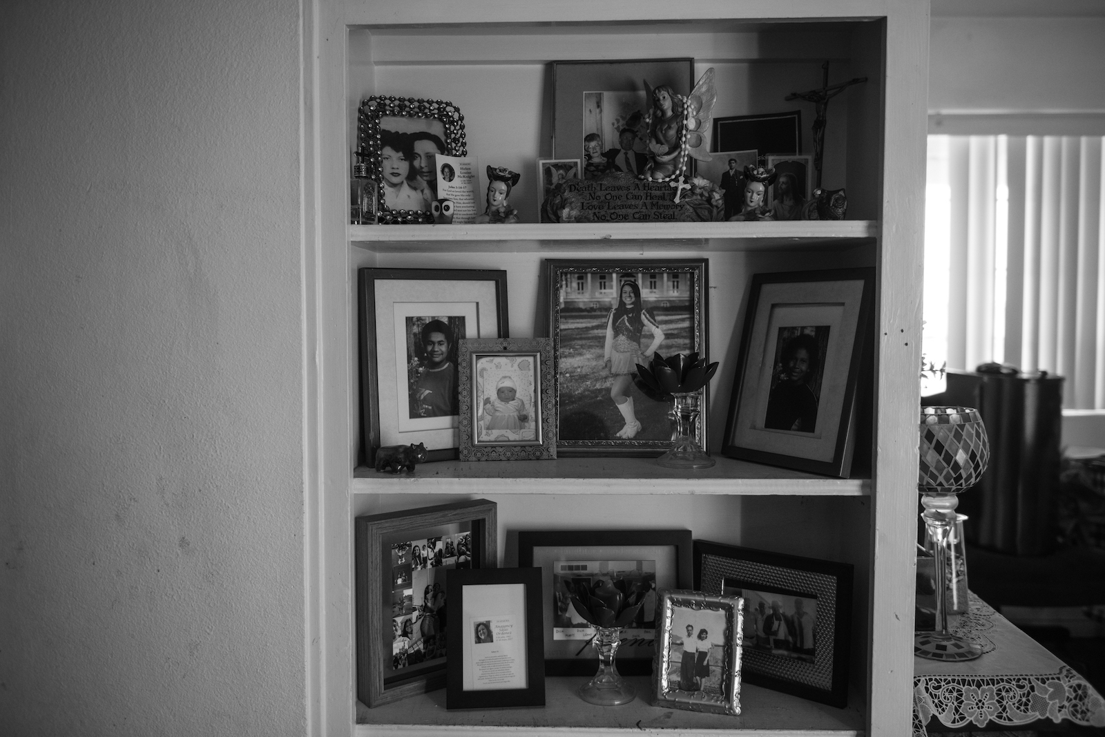 a bookshelf with photos of people