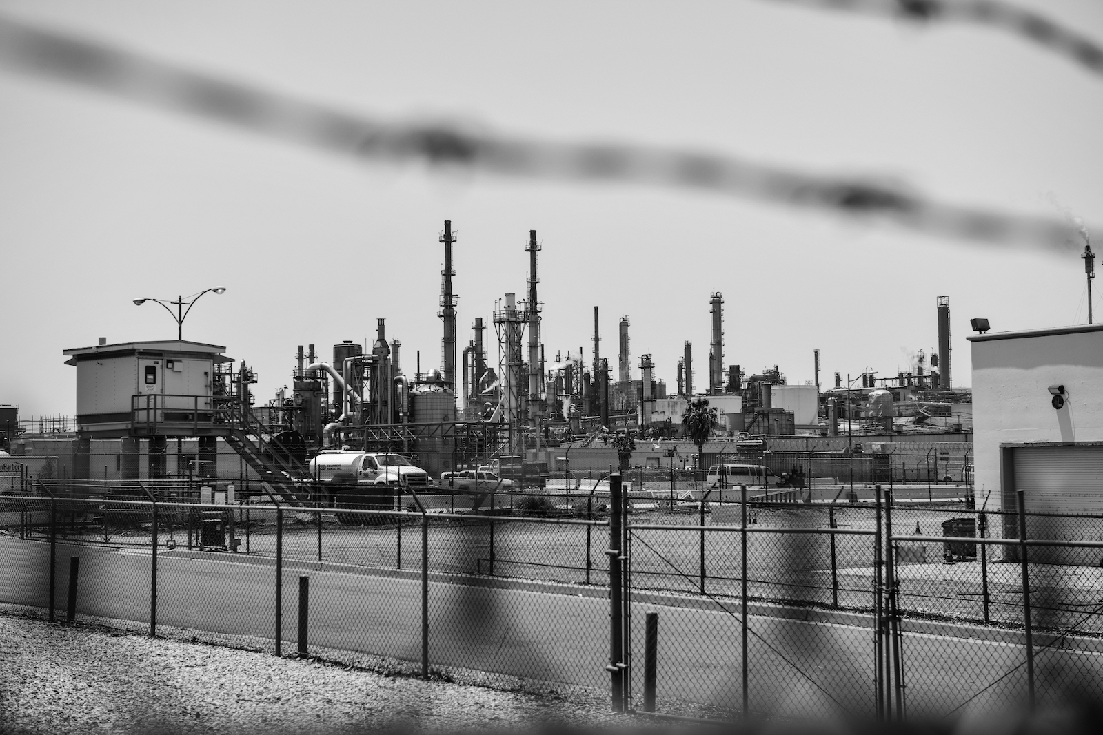barbed wire surrounds an oil refinery