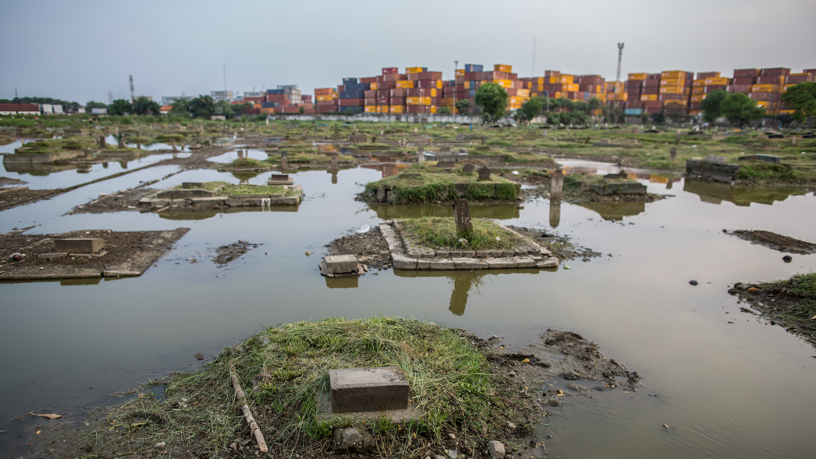 A view of public cemetery which submerged by flood waters from rising sea levels on July 18, 2020 in North Jakarta, Indonesia.