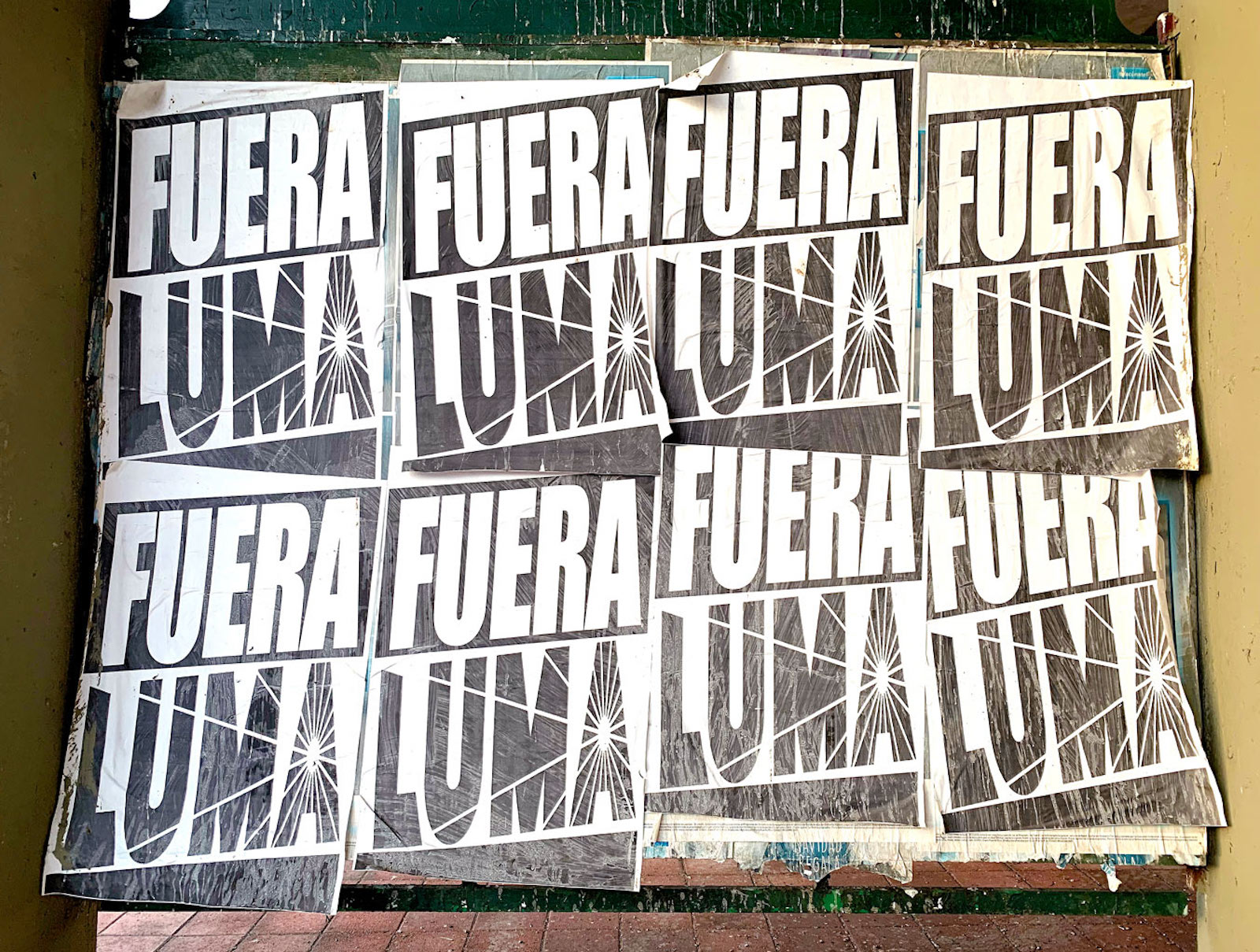 Posters declaring “Fuera Luma,” or “Out with Luma,” appear in Mayagüez, Puerto Rico, near an office of Luma Energy.