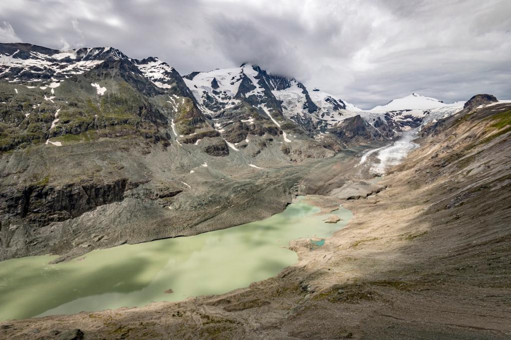 tall mountains with some snow and in the middle a large green patch