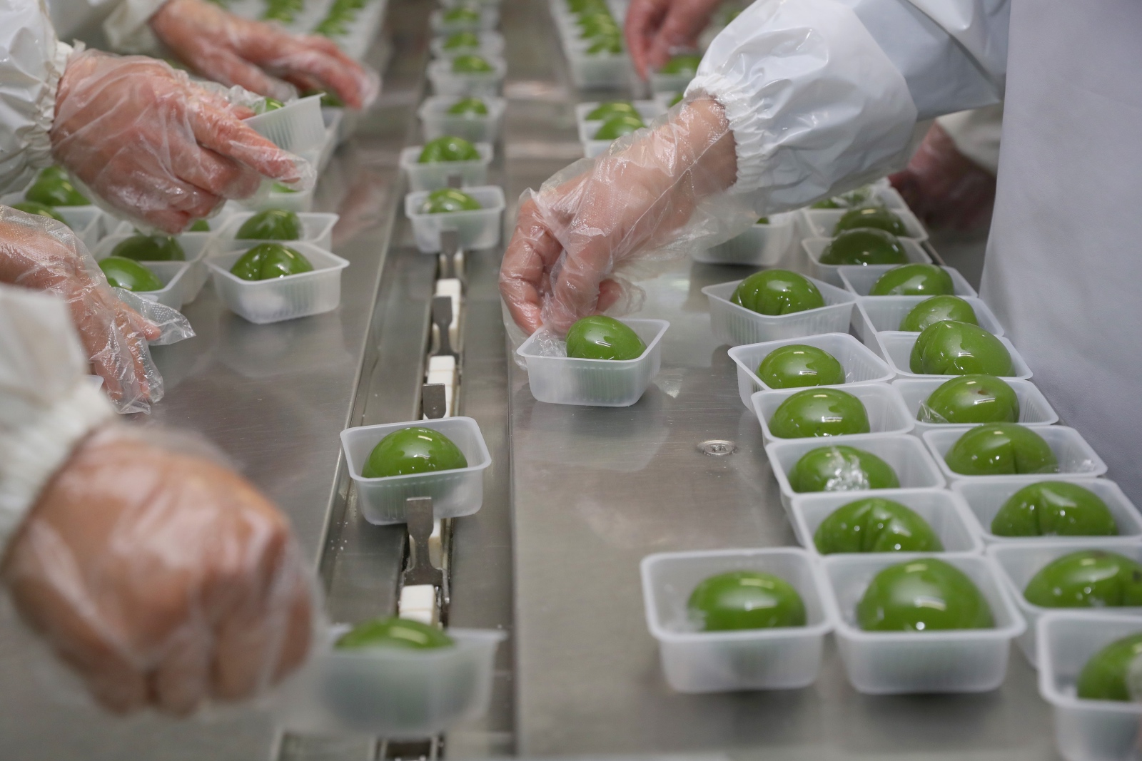 Green dumplings on an assembly line
