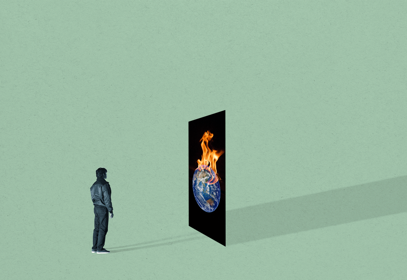A person stands in front of a panel showing the Earth on fire