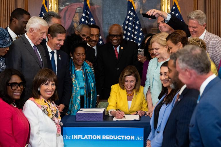 Speaker of the House Nancy Pelosi, D-Calif., signs the Inflation Reduction Act during the bill enrollment ceremony in the Capitol on Friday, August 12, 2022