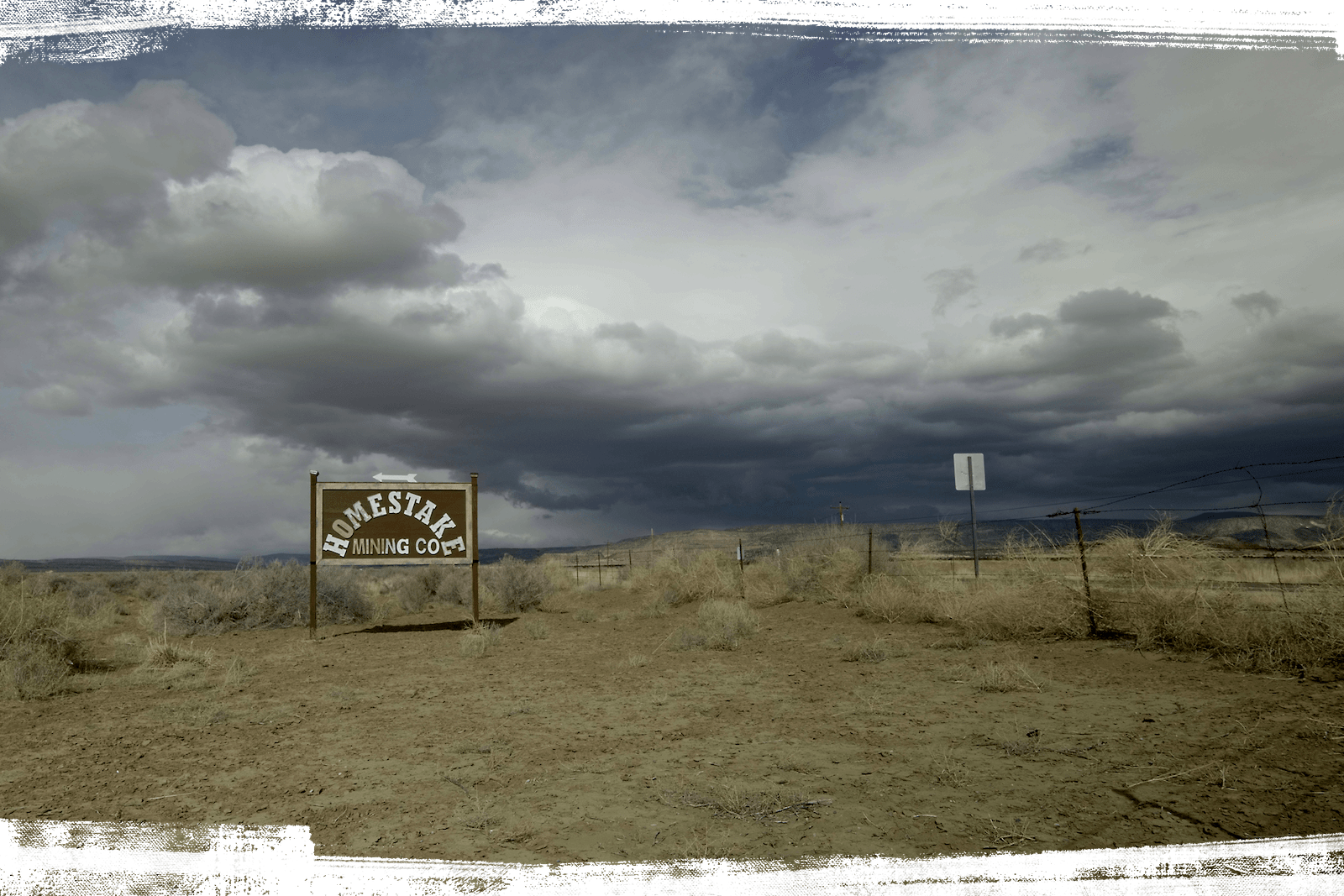 A brown sign demarcating the Homestake mine, surrounded by plains.