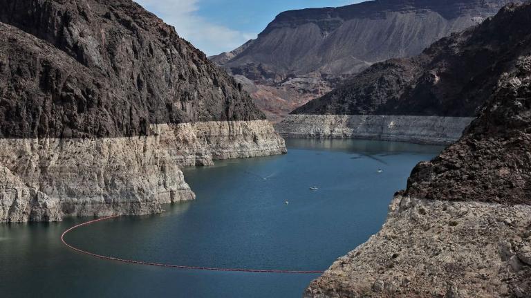 Lake Mead, surrounded by rock formations with bleached "bathtub rings" showing how far the water level has dropped