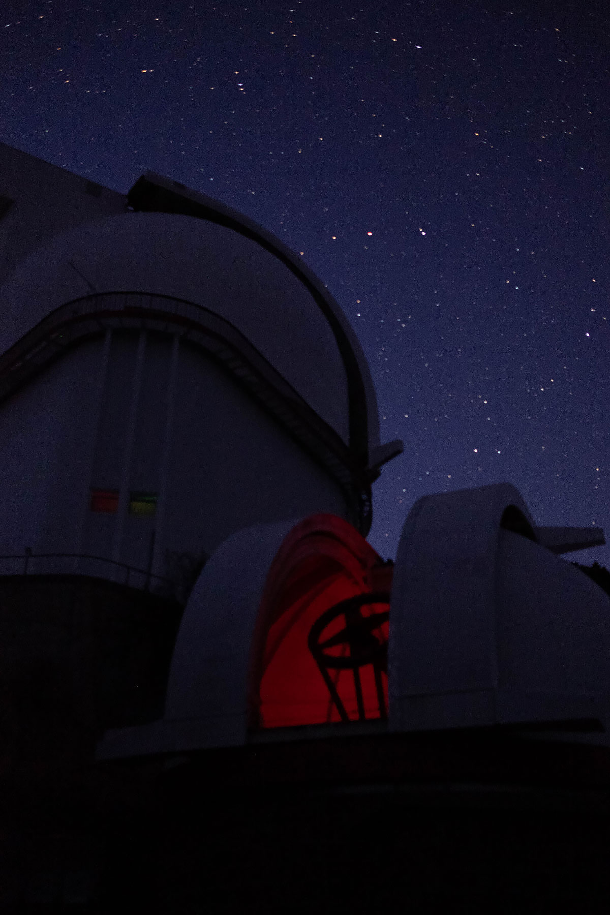 A picture of a telescope at work, at night.