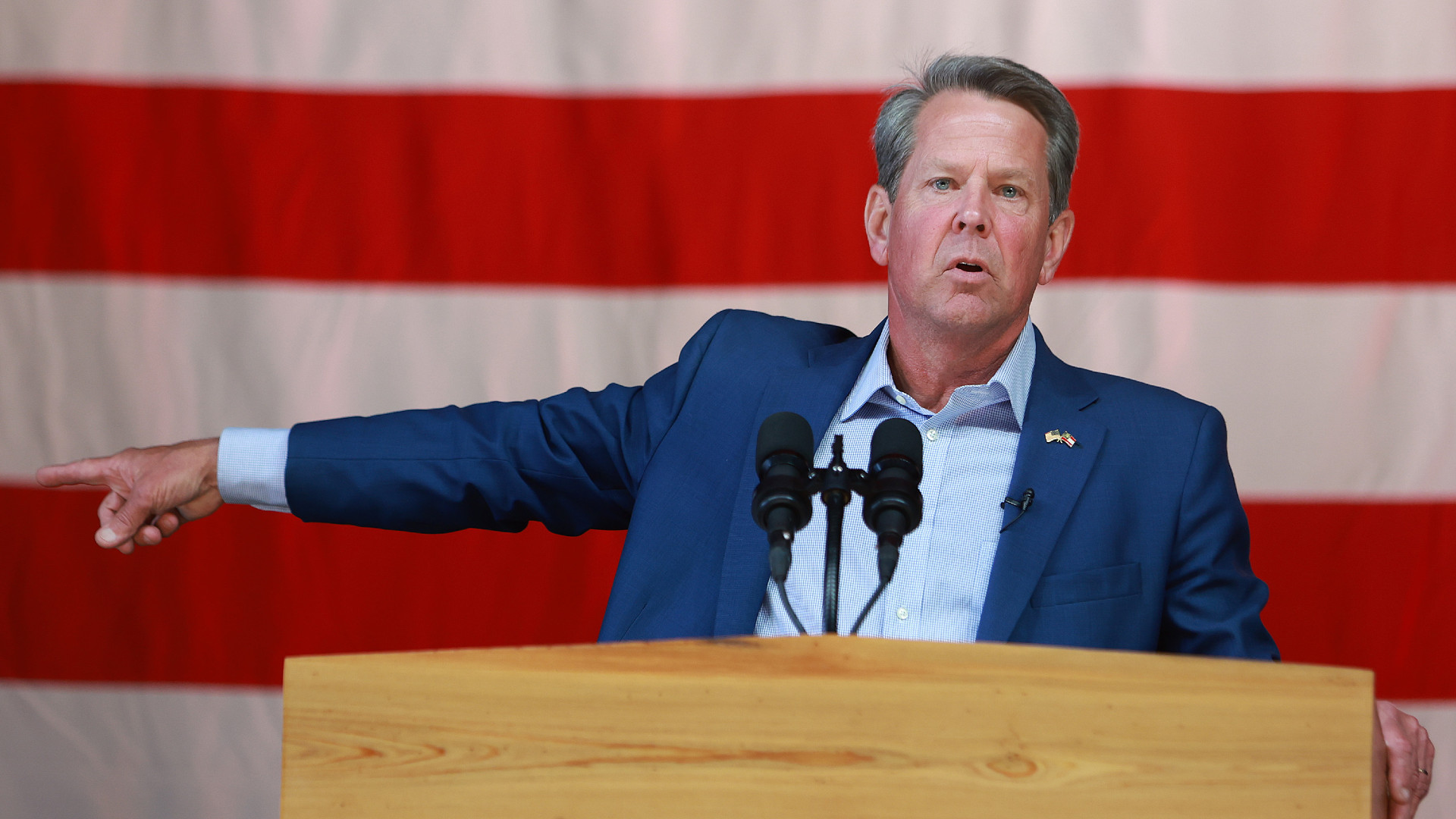 Georgia Gov. Brian Kemp speaks at a campaign event attended by former U.S. Vice President Mike Pence at the Cobb County International Airport on May 23, 2022 in Kennesaw, Georgia. Kemp is running for reelection against former U.S. Sen. David Perdue in tomorrow's Republican gubernatorial primary.