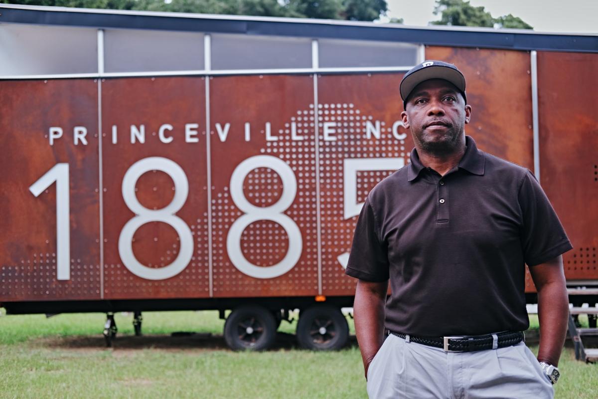 Calvin Adkins, a former resident of Princeville, stands in front of the town's museum in 2022.