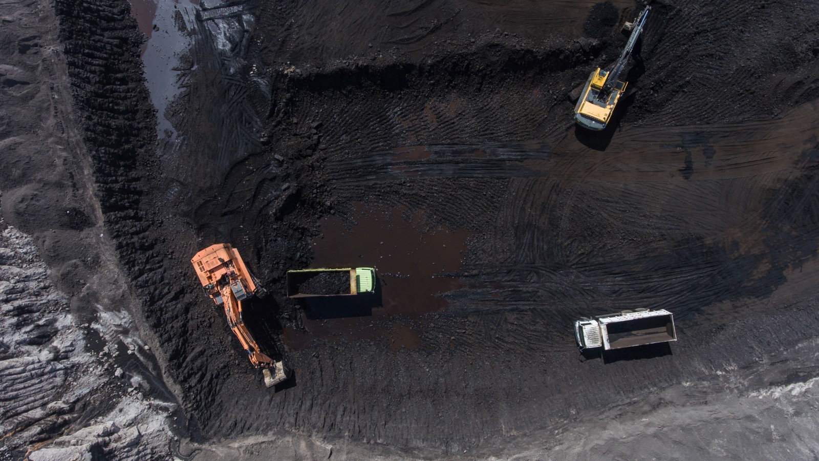 Aerial view of coal mine with construction vehicles in Indonesia