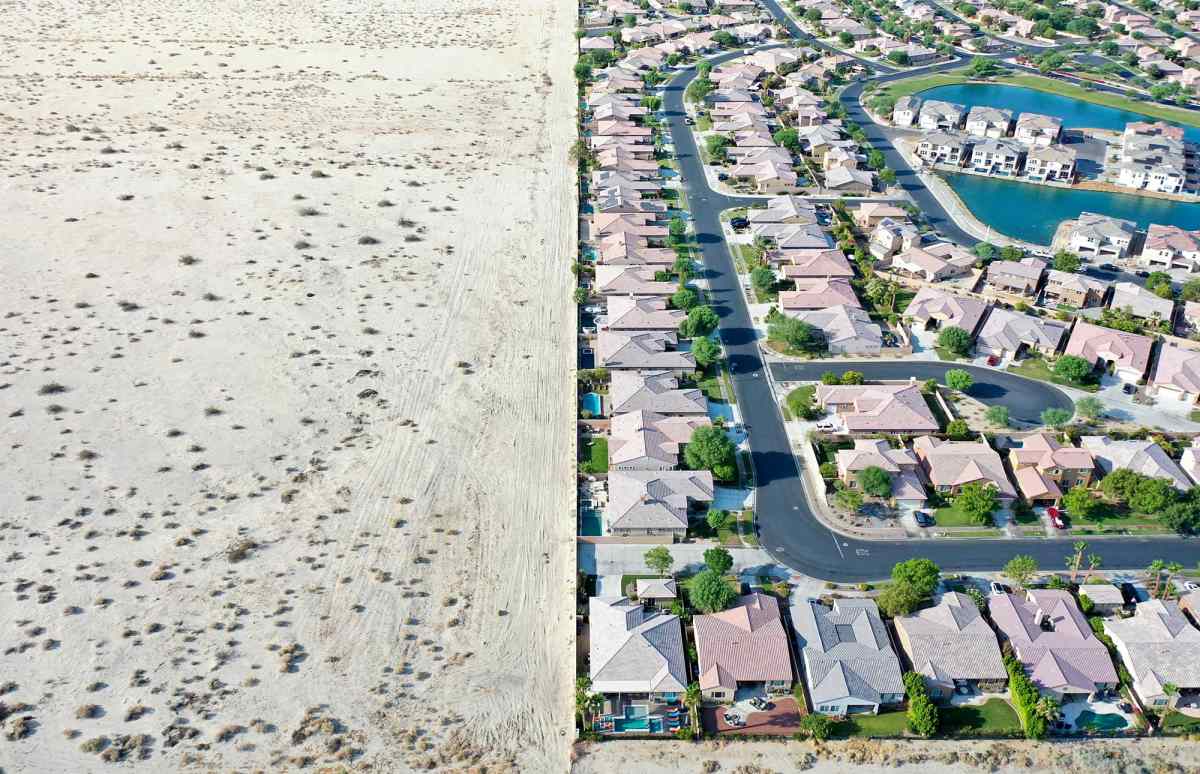 Aerial view of homes next to undeveloped desert in Indio, California.