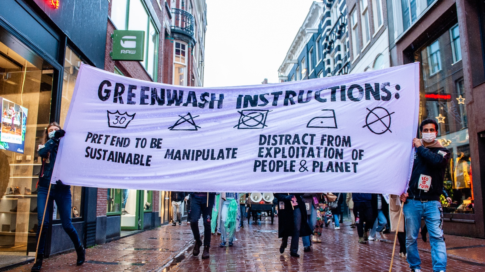 A protest banner spells out instructions for greenwashing