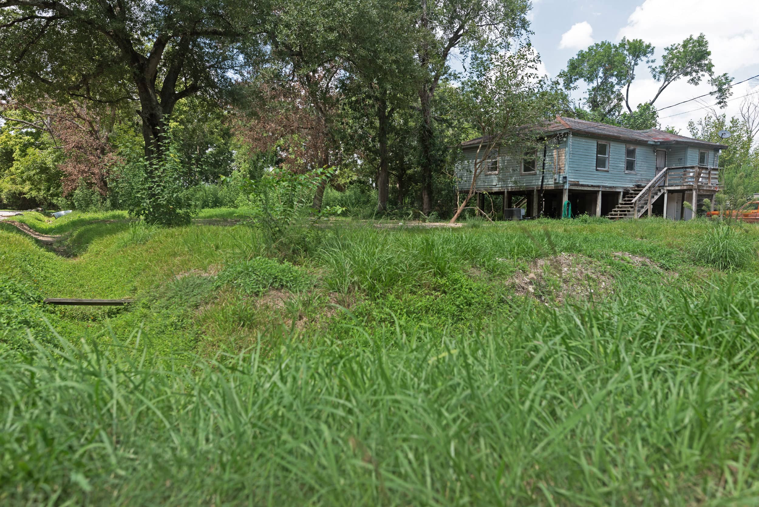 A grass-covered lot where a home once stood