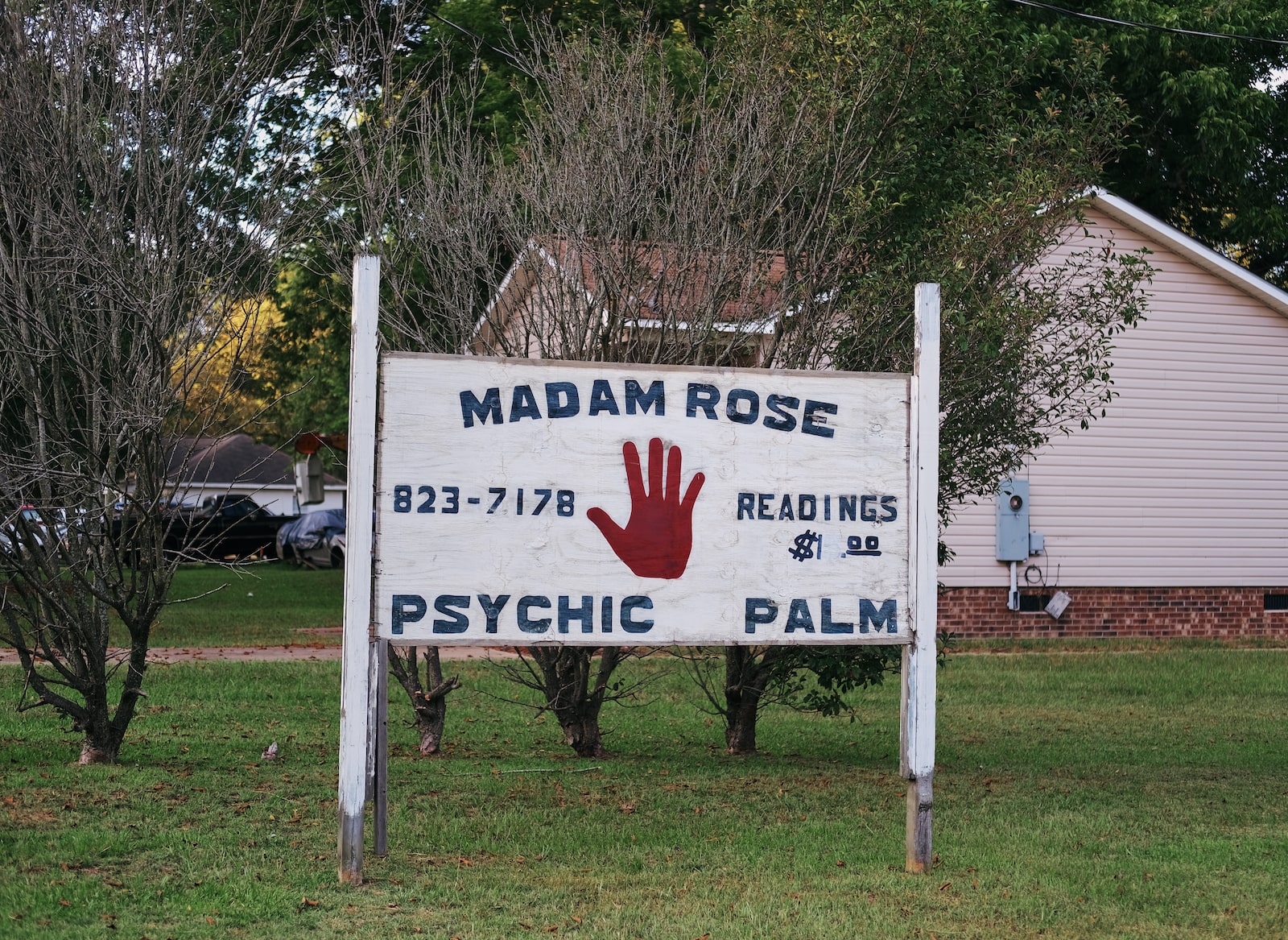 A white sign with a red palm painted on it