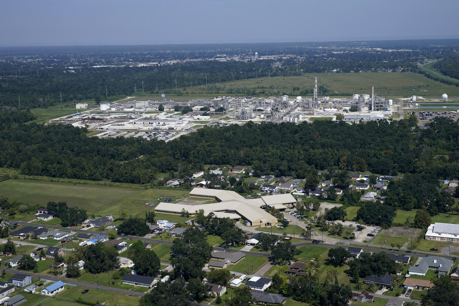 an aerial view of an industrial plant in front of a residential neighborhood