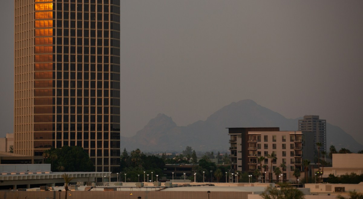 Camelback Mountain is visible through hazy, hot air at sunset on June 15, 2021 in Phoenix, Arizona.