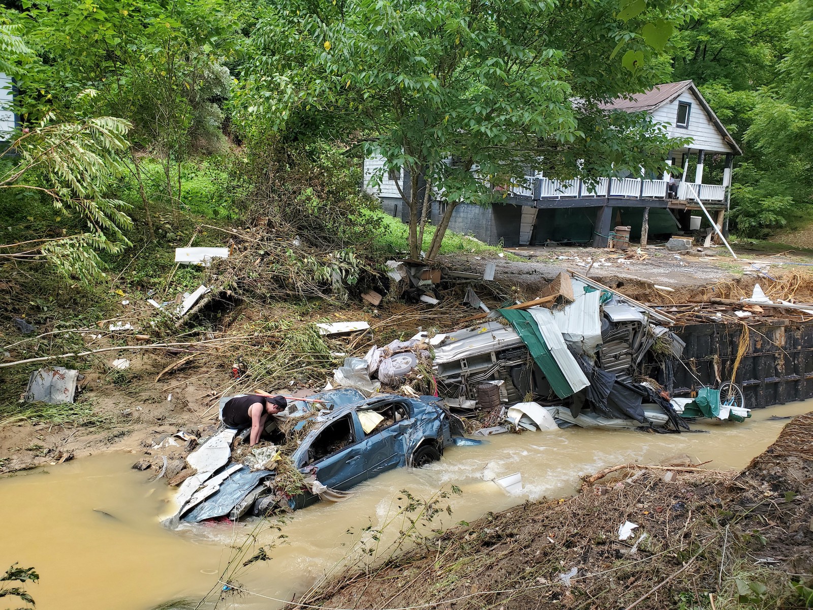 A house and vehicles destroyed by heavy rain-caused flooding in Central Appalachia in Kentucky, the United States