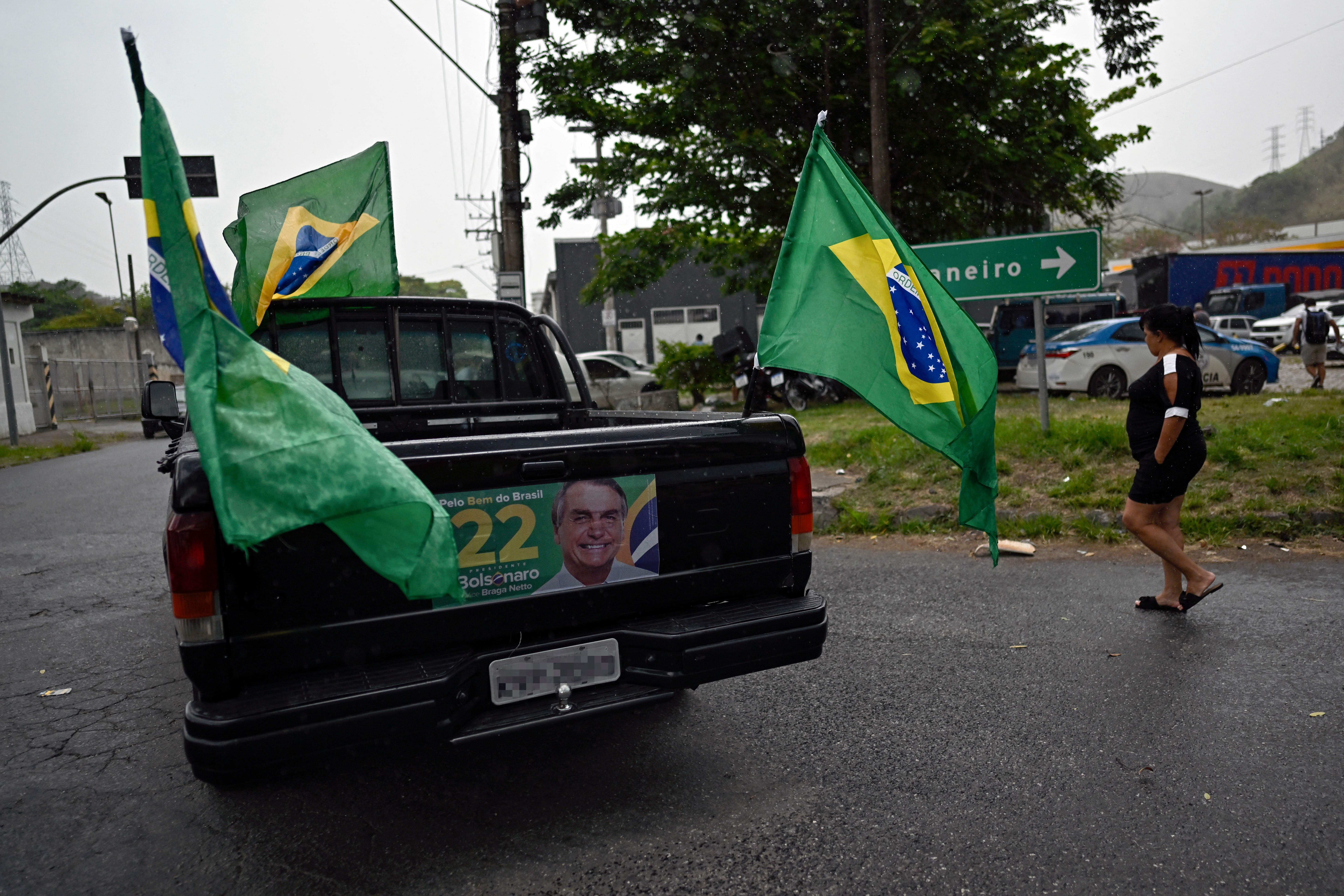 A pick-up truck displays Brazilian flags and political propaganda with an image of President Jair Bolsonaro