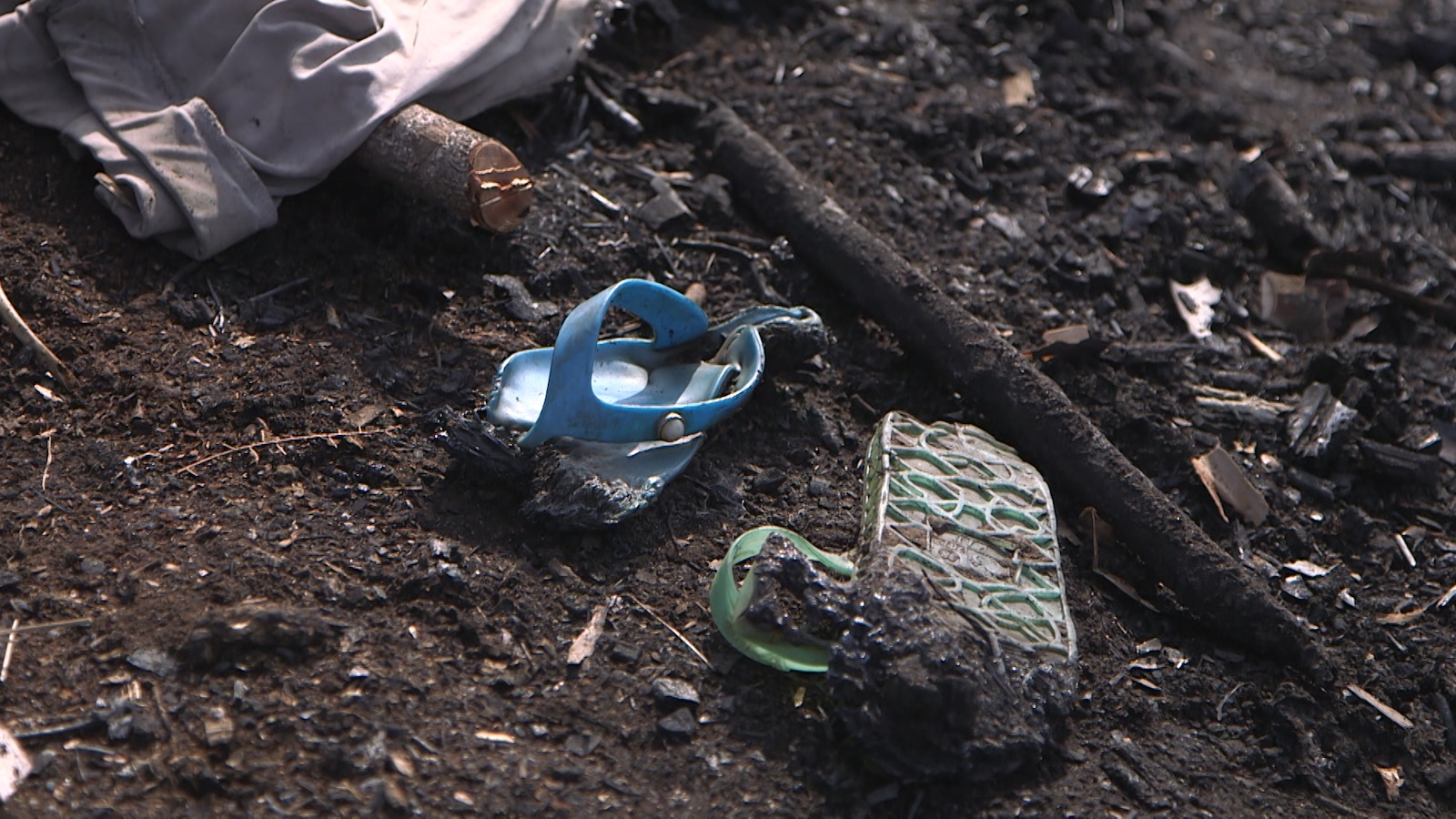 two sandals lying in dirt