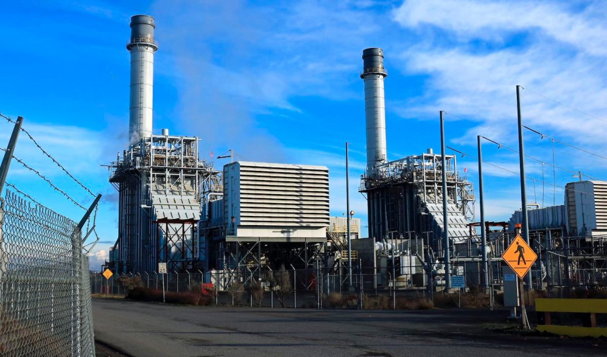 natural gas power plant against a blue sky