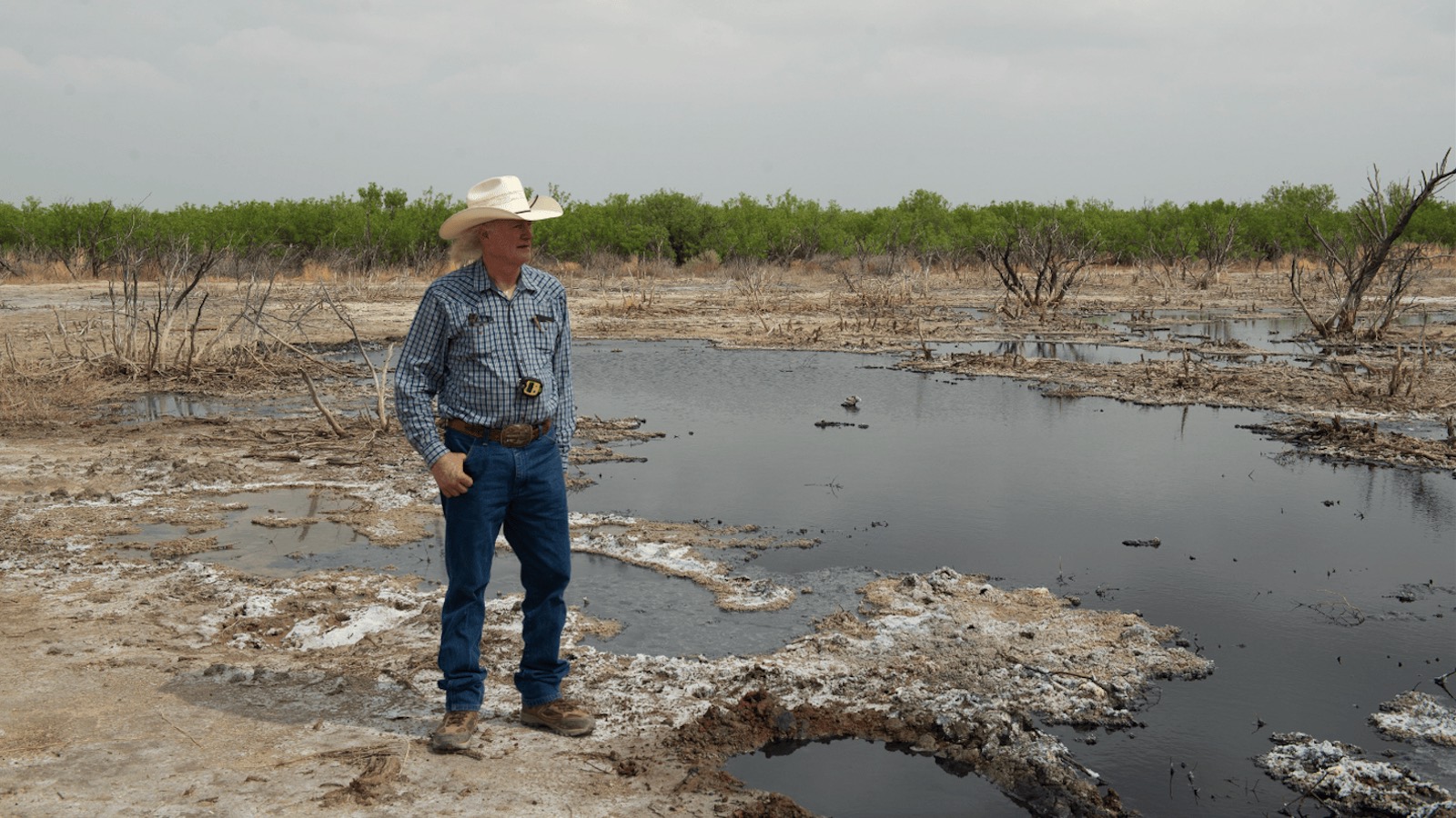 A photo of rancher Schuler Wight at one of the 100 abandoned wells on his property.