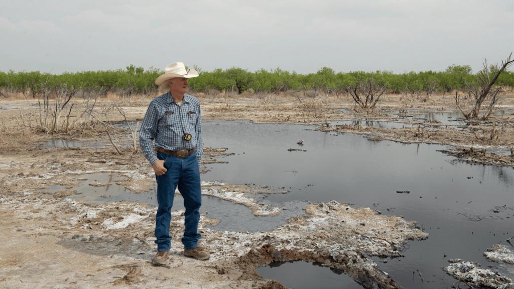 A photo of rancher Schuler Wight at one of the 100 abandoned wells on his property.