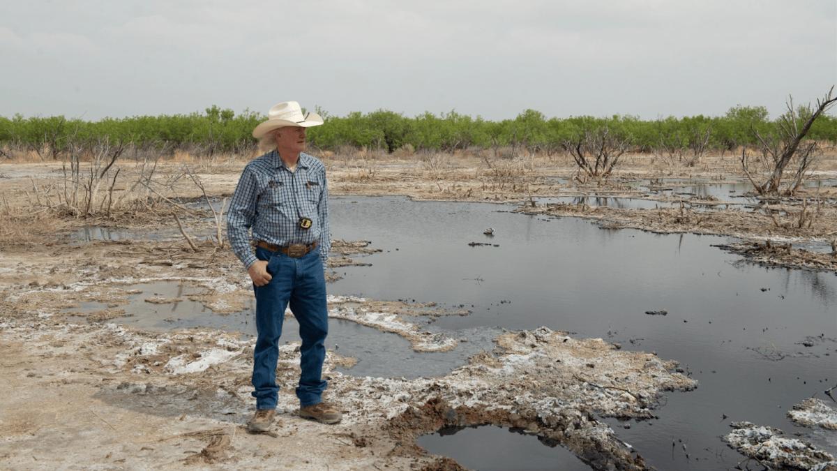 A photo of rancher Schuler Wight at one of the 100 abandoned wells on his property.