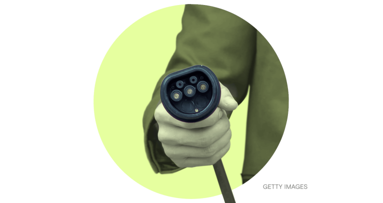 Male hand holding an EV charger