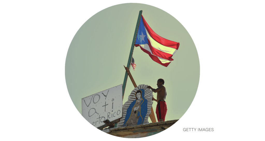 A man places a placard that read in spanish 