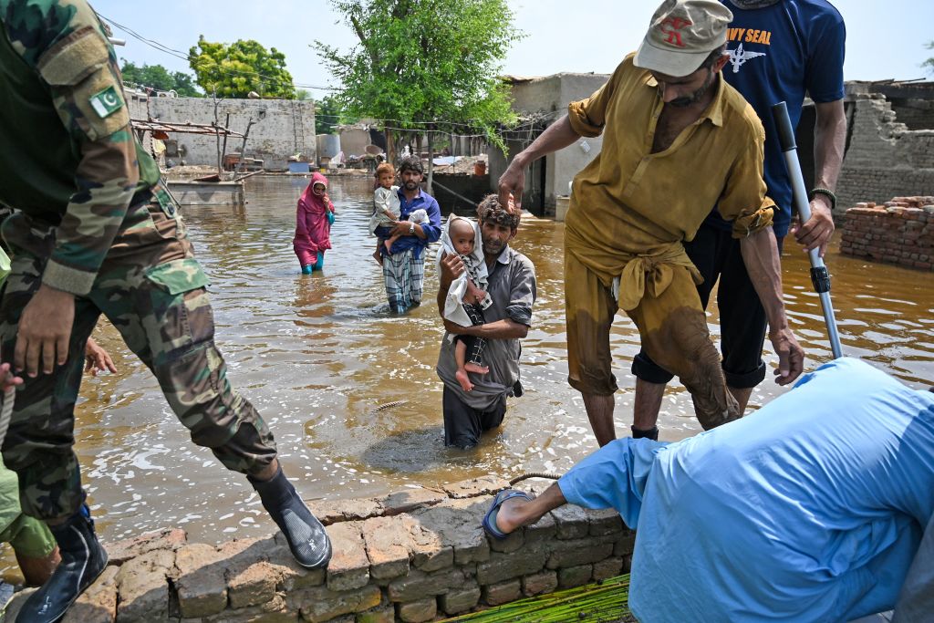 Pakistani naval personnel rescue people from floods.