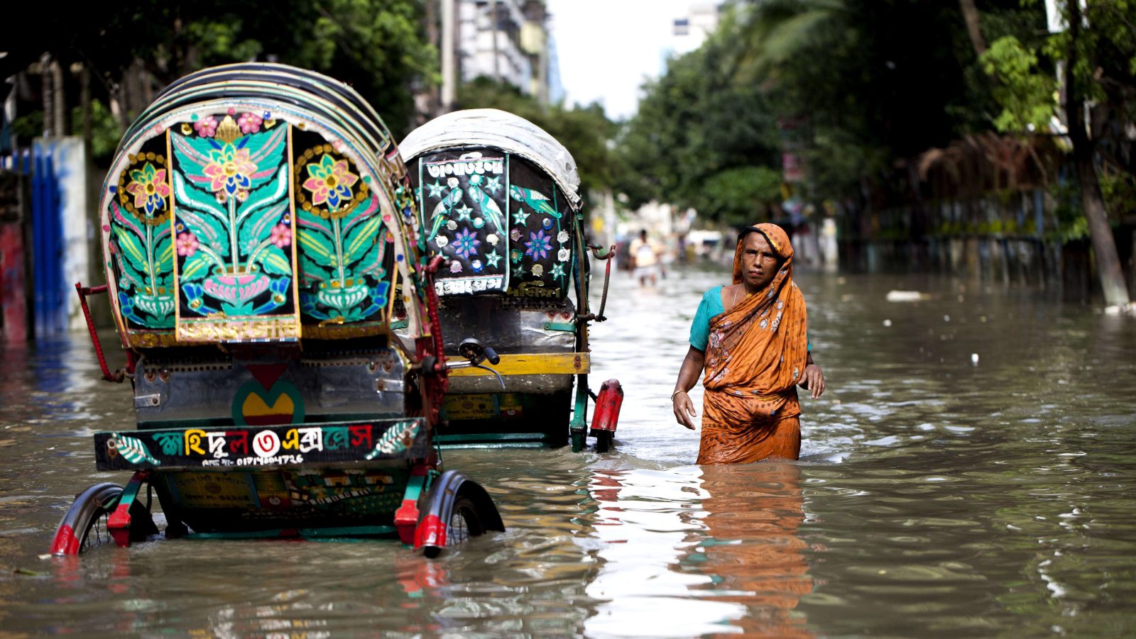 Rickshaws traveling through a flooded area of Chittagong.