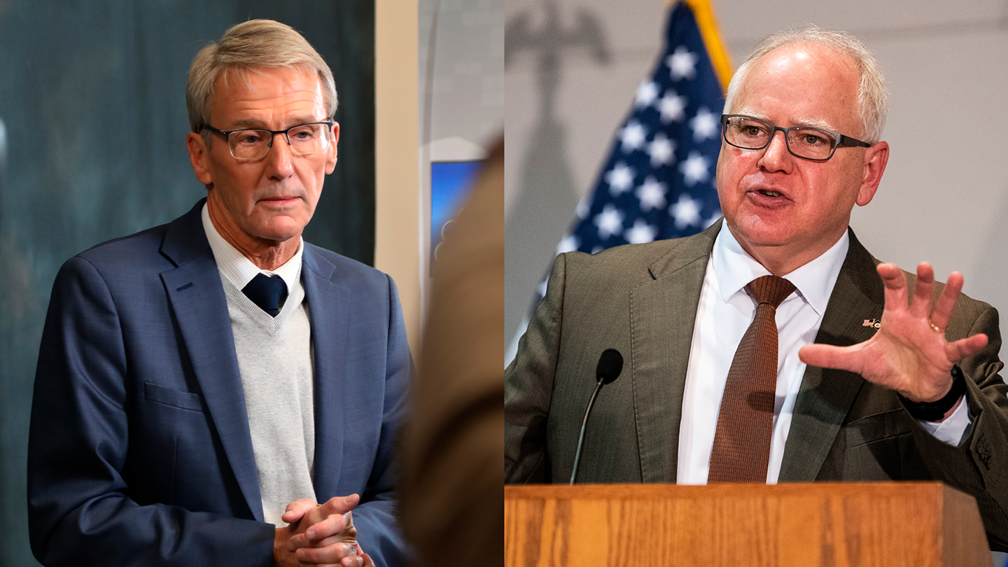 In the left frame, a man with white hair, glasses, and a blue suit holds his hands together, while in the right frame, a man with glasses and a bald head speaks at a podium.