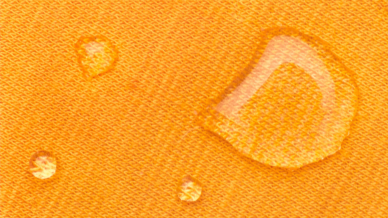 Water droplets on orange fabric
