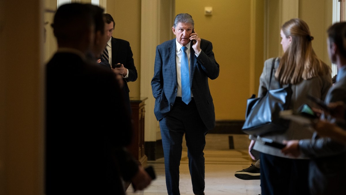Senator Joe Manchin of West Virginia talks on the phone outside of a meeting with Senate Democrats at the U.S. Capitol.