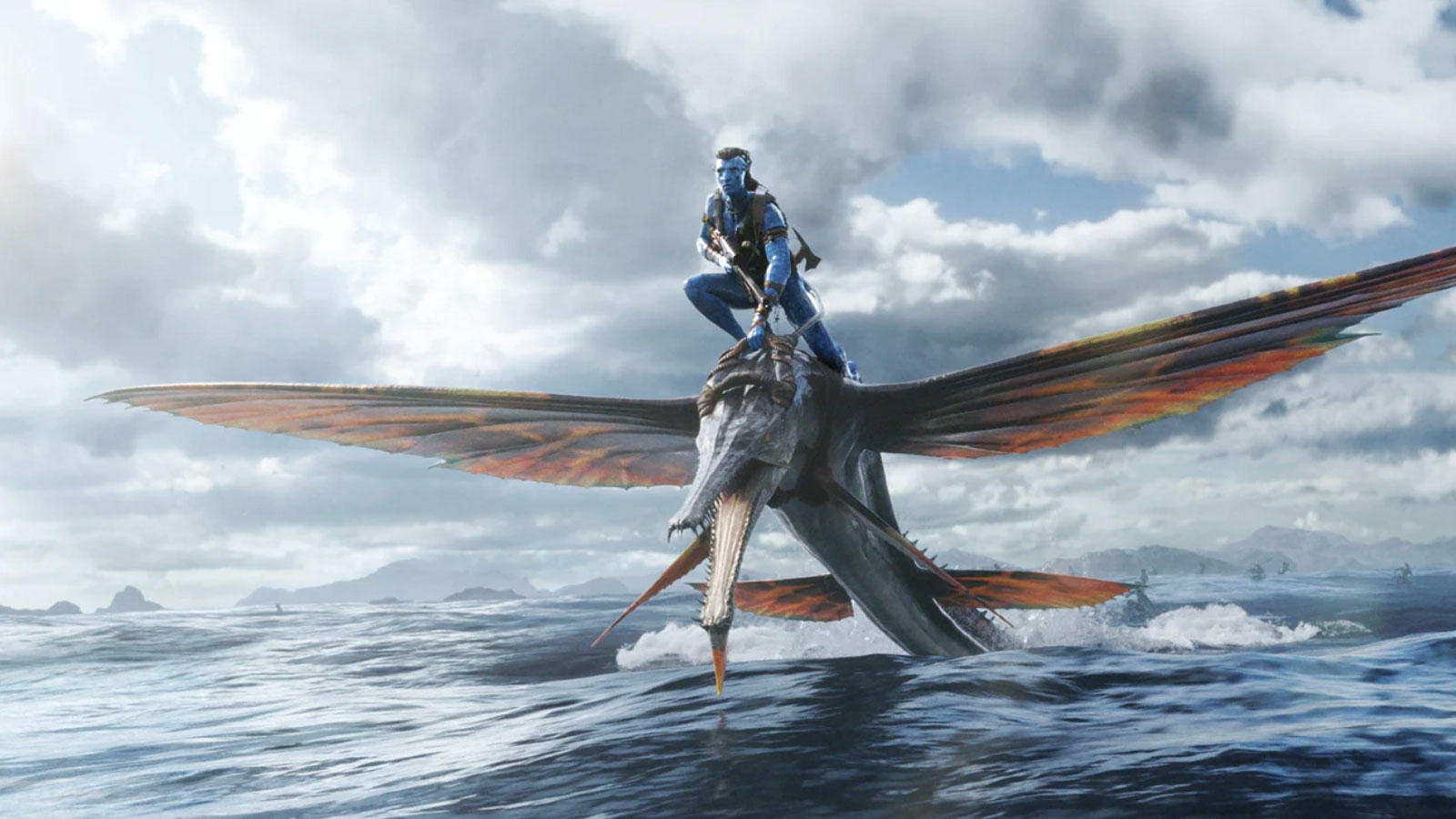Screenshot from Avatar 2; a blue person riding a sea creature that looks like a cross between a flying fish and an alligator