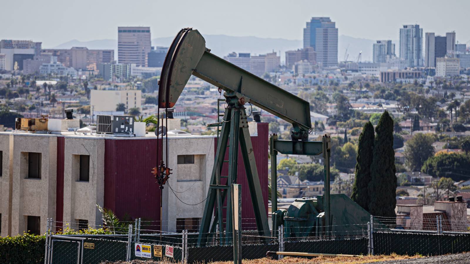 Oil well and pump jacks in the City of Signal Hill with the City of Long Beach in the background.