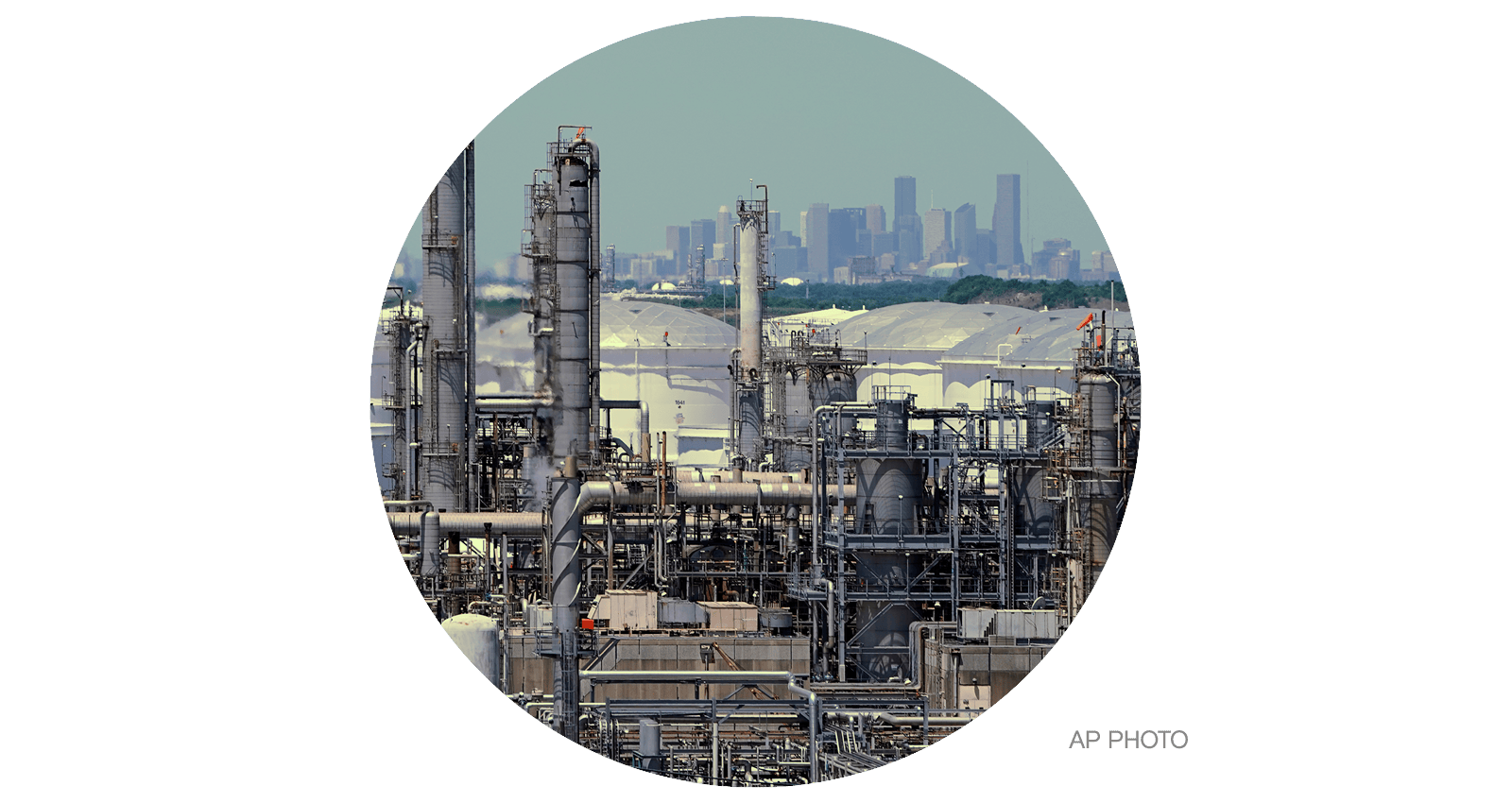 A refinery along the Houston Ship Channel is seen with downtown Houston in the background
