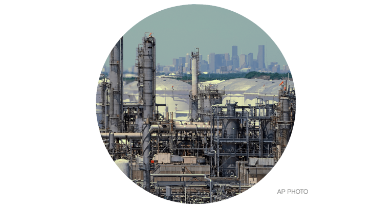 A refinery along the Houston Ship Channel with downtown Houston in the background