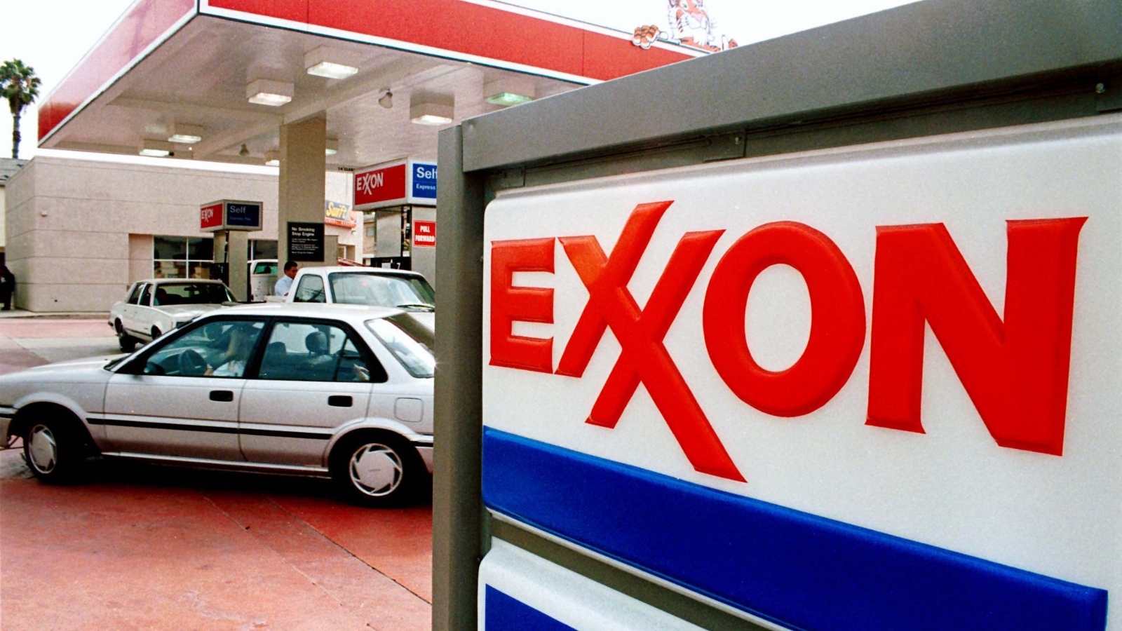 1990s-era photo of car at an Exxon gas station.