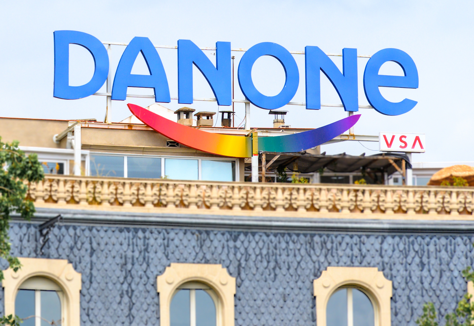 Danone logo in blue on top of an old building